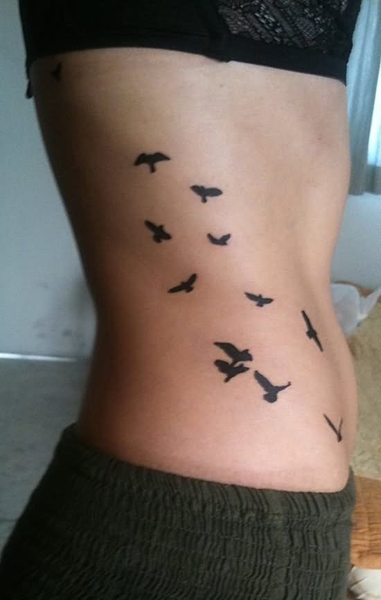 Black Flying Birds Tattoo On Girl Side Rib