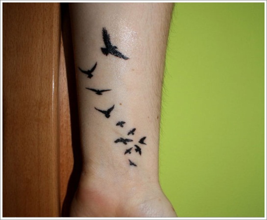 Black Flying Birds Tattoo On Wrist