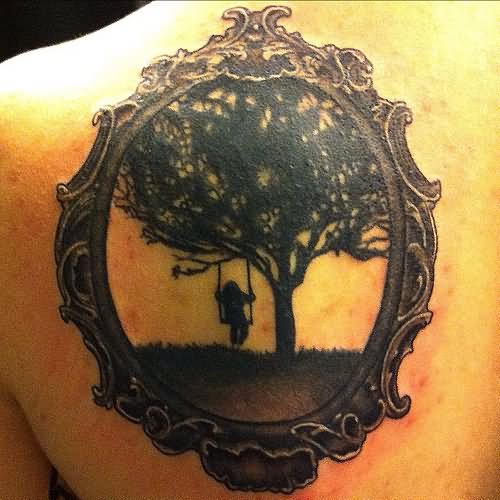 Black Girl Swinging From Tree In Frame Tattoo On Left Back Shoulder