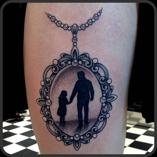 Black Ink Dad And Daughter In Frame Tattoo Design