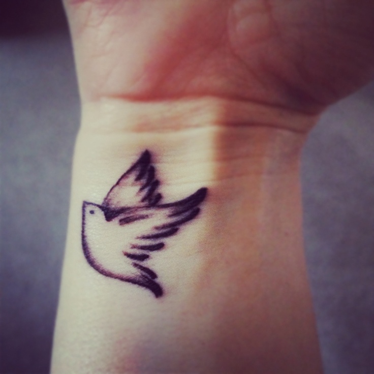 Black Ink Flying Bird Tattoo On Wrist