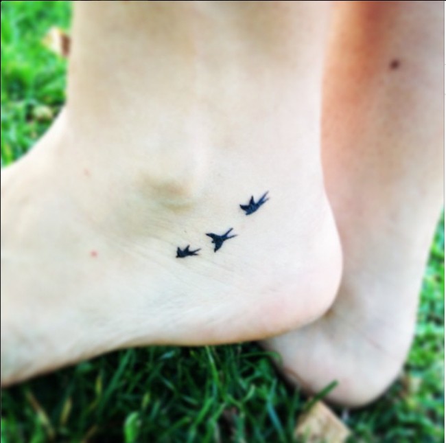 Black Ink Little Three Flying Bird Tattoo On Heel