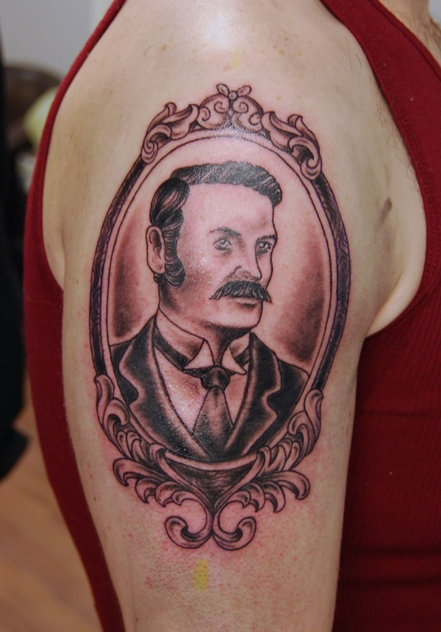 Black Ink Man Portrait In Frame Tattoo On Right Shoulder