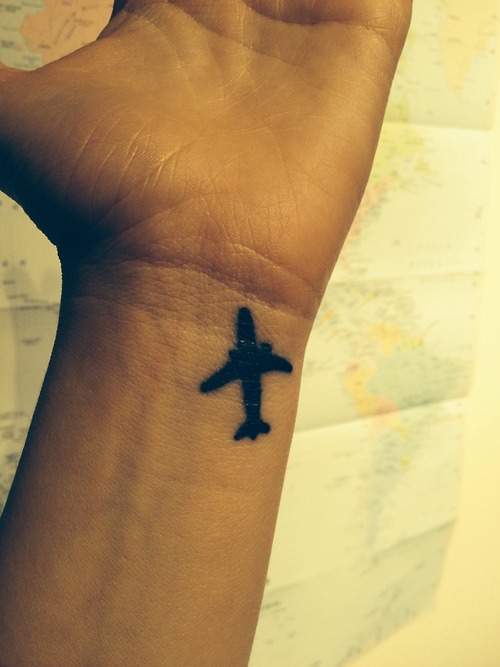 Black Little Airplane Tattoo On Wrist