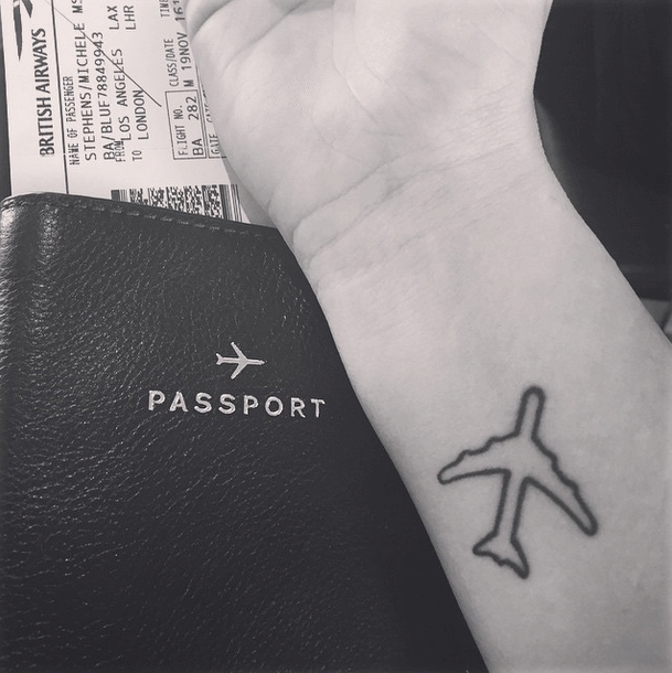Black Outline Airplane Tattoo On Wrist