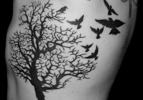 Black Tree Without Leaves With Flying Birds Tattoo Design For Side Rib