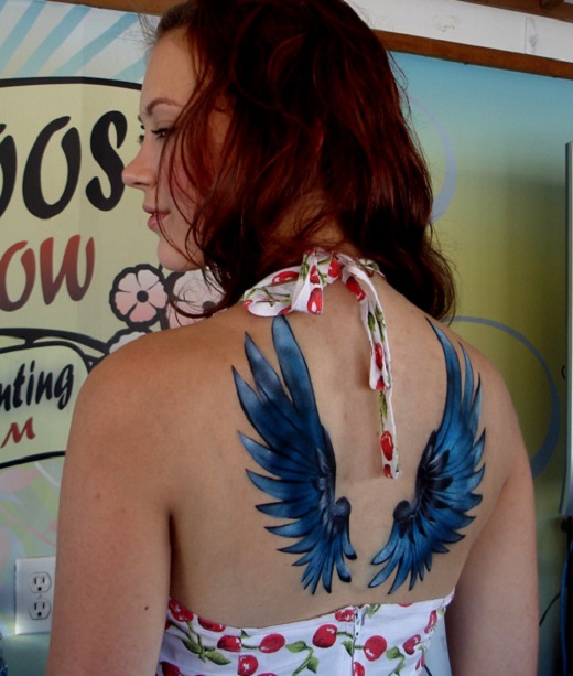 Blue And Black Airbrush Wings Tattoo On Girl Upper Back
