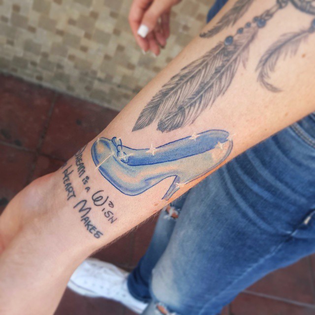Blue Ink Girl Slipper Tattoo On Forearm