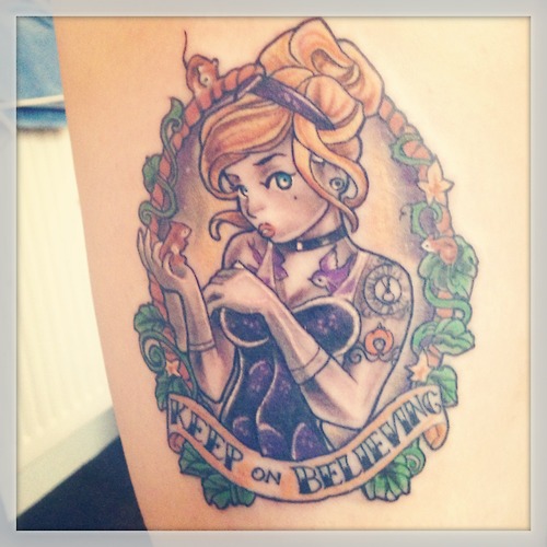 Cartoon Girl Face In Frame With Banner Tattoo Design