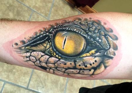 Classic Alligator Eye Tattoo Design For Forearm
