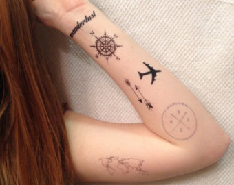 Compass With Airplane Tattoo On Girl Left Forearm