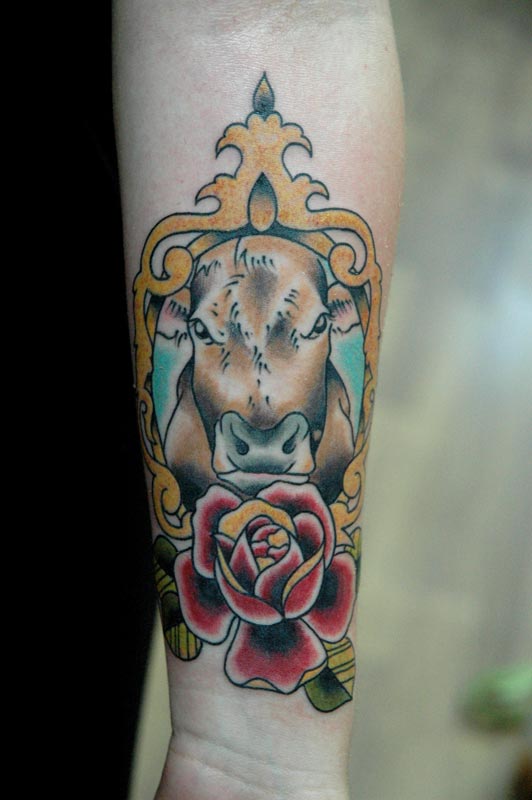 Cow In Frame With Rose Tattoo On Forearm