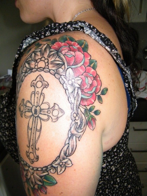 Cross In Frame With Roses Tattoo On Girl Left Shoulder