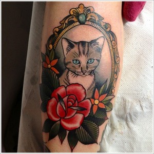 Cute Cat In Frame With Flowers Tattoo Design