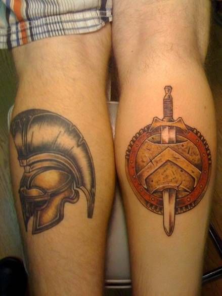 Dagger And Spartan Helmet Tattoos On Back Legs