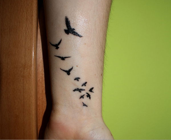 Flying Black Birds Tattoos On Wrist