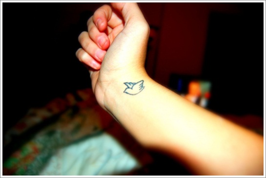 Girl Showing Her Wrist Bird Tattoo