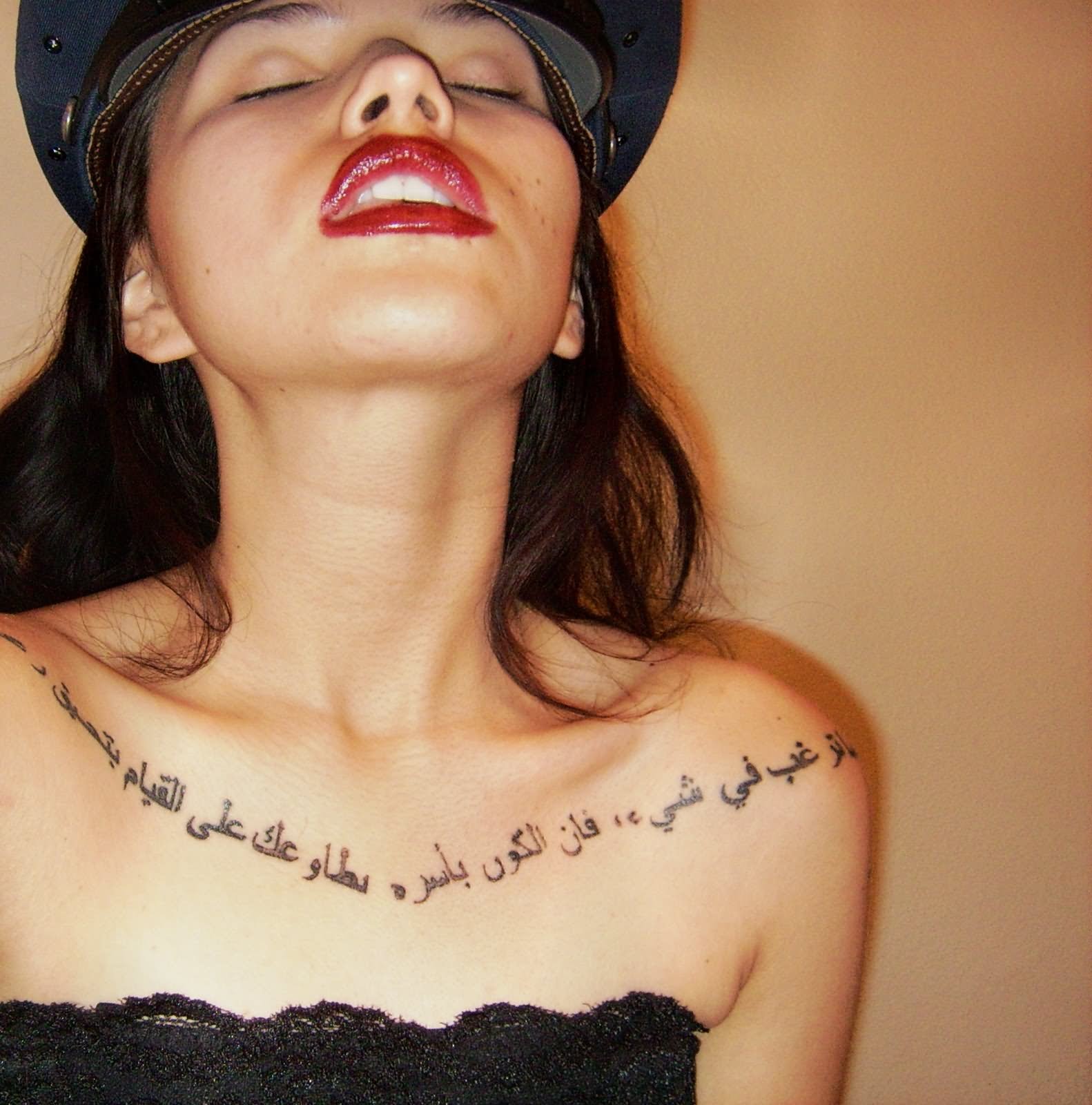 Girl With Arabic Tattoos On Collarbones