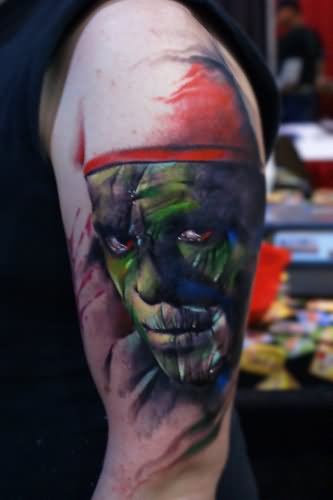 Green Ink Mummy Face Tattoo On Left Half Sleeve