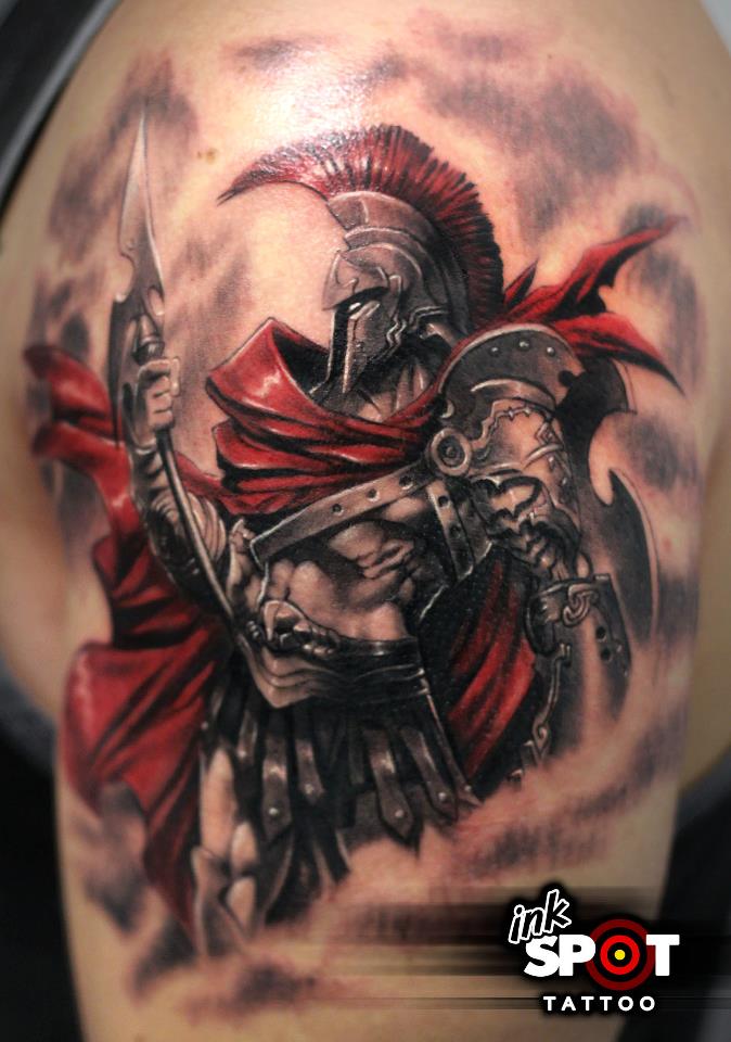 Grey And Red Spartan Tattoo On Man Left Shoulder