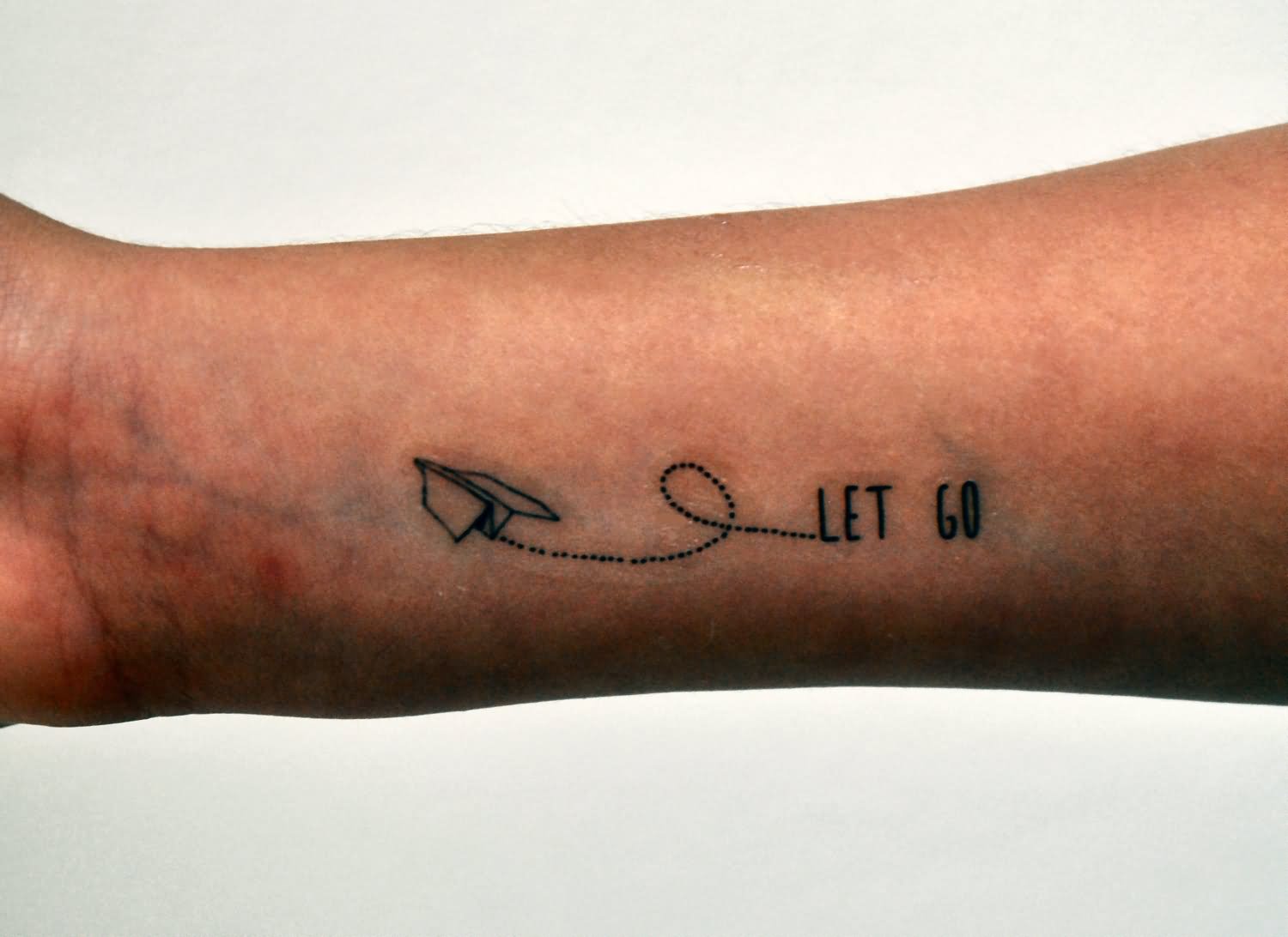 Let Go - Paper Plane Tattoo On Forearm