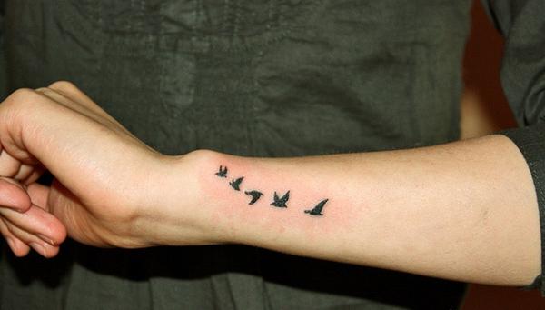 Little Black Five Flying Birds Tattoo On Side Wrist