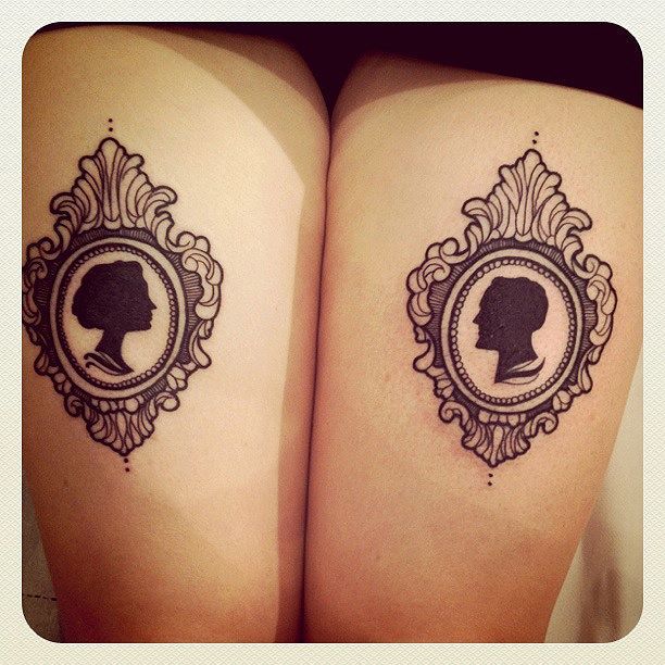 Man And Women Head In Two Frame Tattoo On Both Thigh