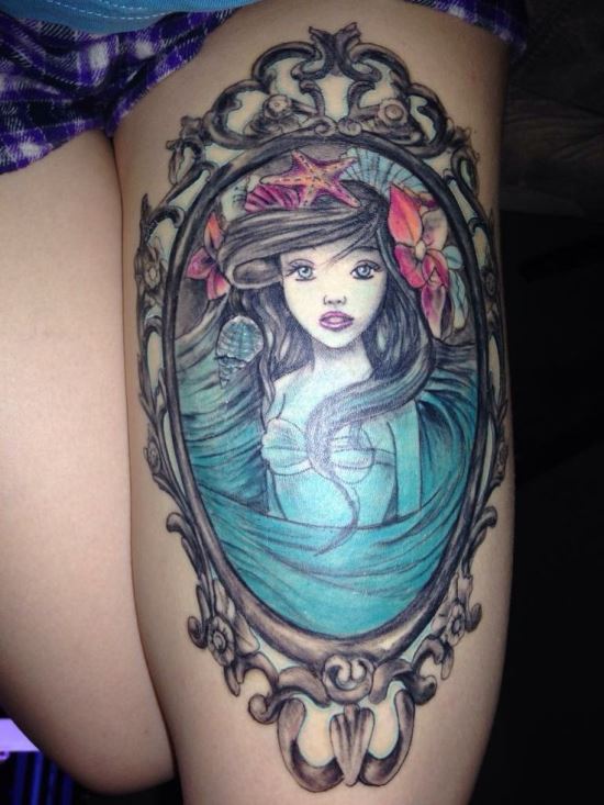 Mermaid In Frame Tattoo On Girl Thigh