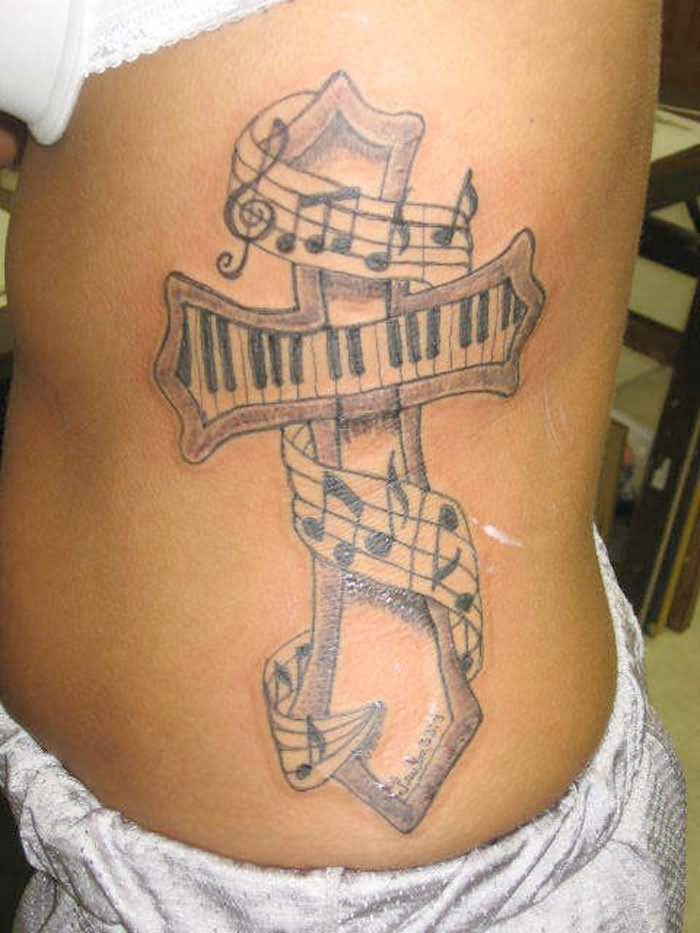 Music Keyboard In Cross Tattoo Design For Side Rib