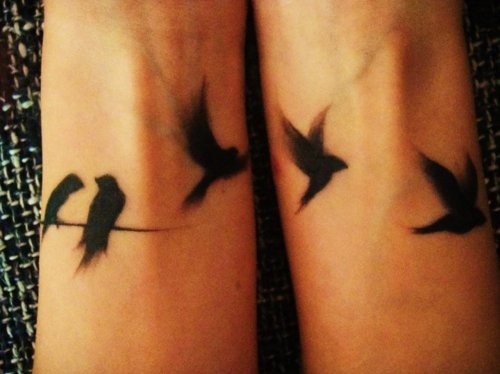 Nice Flying Black Birds Tattoos On Wrists