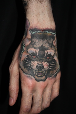 Red Eyes Raccoon Tattoo On Left Hand