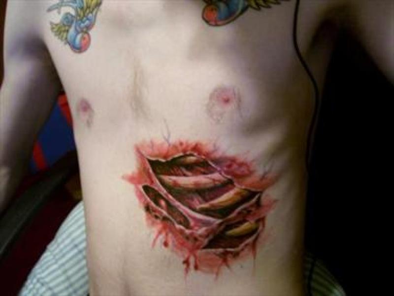Red Ink 3D Ripped Skin Rib Cage Tattoo On Under Chest