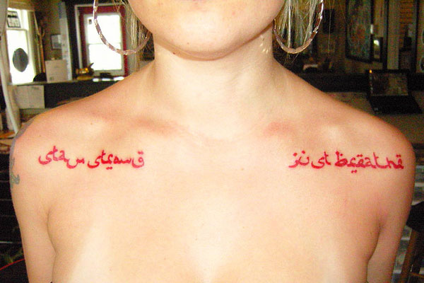 Red ink Arabic Tattoos On Front Shoulders