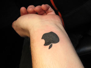 Black Apple Logo Tattoo On Wrist