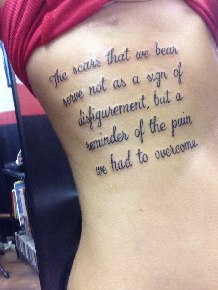 Girl Showing Her Cancer Quote Tattoo On Side Rib