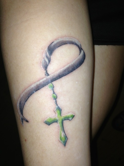 Green Cross And Grey Ribbon Tattoo On Arm