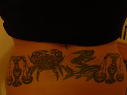 Red And Black Tribal Cancer Tattoo On Lower Back