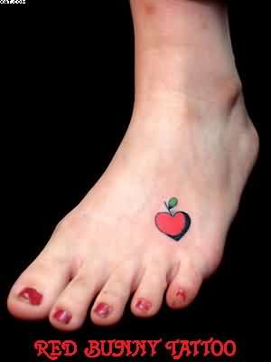 Red Heart Shape Apple Tattoo On Girl Foot