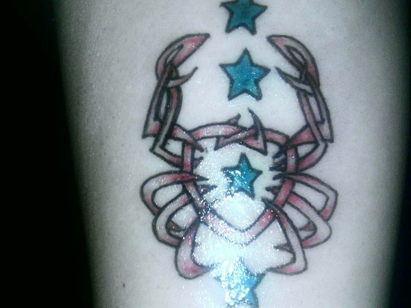 Stars And Cancer Crab Tattoo On Arm