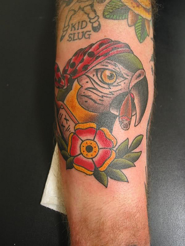 Traditional Parrot Head With Flower Tattoo Design For Arm