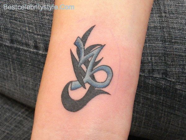 Black And Blue Capricorn Sun Sign Tattoo On Arm