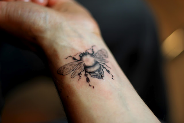 Black And Grey Bee Tattoo On Wrist