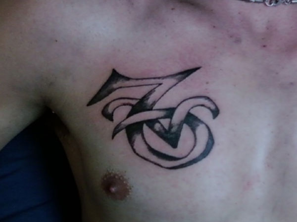 Black And Grey Capricorn Tattoo On Chest For Men