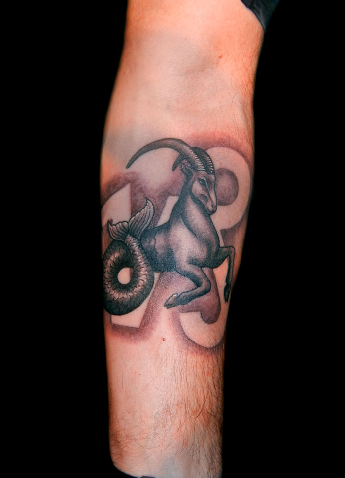 Black And Grey Goat Capricorn Tattoo On Forearm
