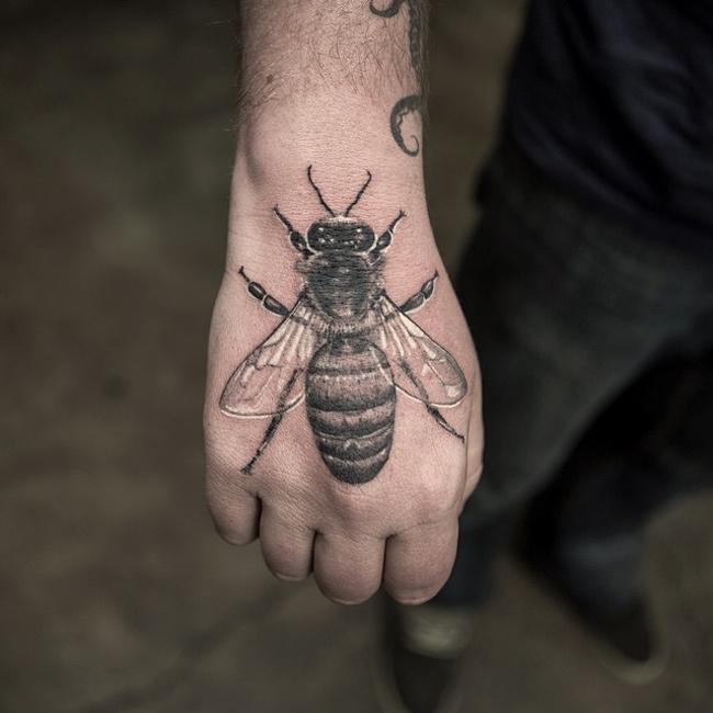 Black And Grey Realistic Bee Tattoo On Hand