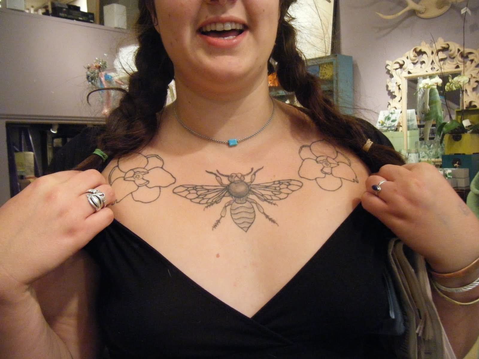 Black Bee And Flowers Tattoo On Girl Collarbone