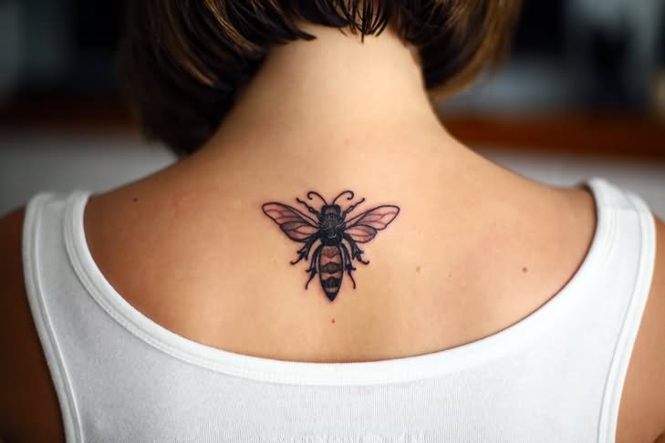 Black Bee Tattoo On Girl Upper Back