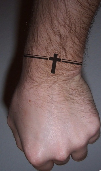 Black Cross Wristband Tattoo On Upper Wrist