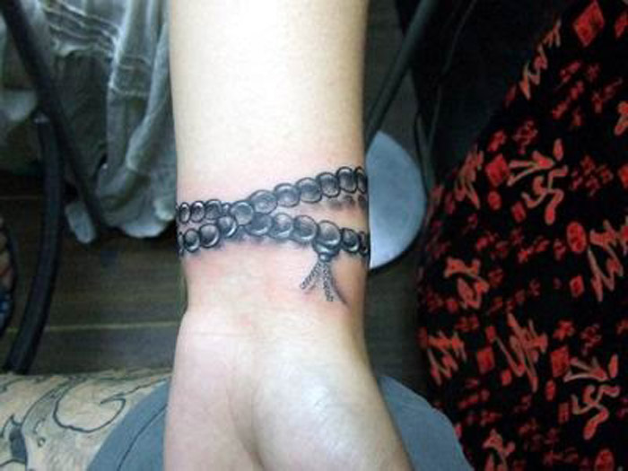 Black Ink Rosary Wristband Tattoo On Wrist