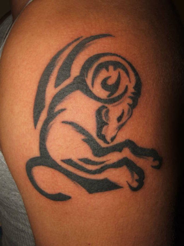Black Ink Tribal Capricorn Tattoo On Half Sleeve